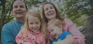 parents holding their kids and smiling