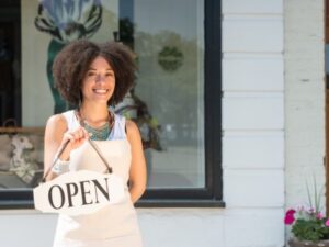 Texas Business Owner woman holding open sign wants to protect her personal assets