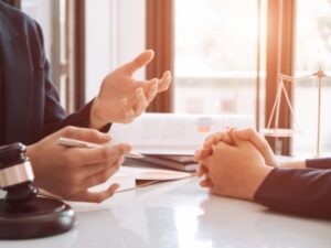 attorney and woman hands on table to set up special needs trust to protect benefits of child with disabilities