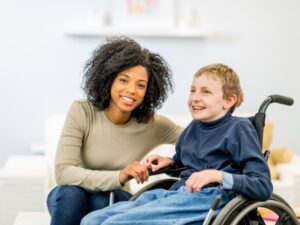 woman and child with disabilities in wheelchair. Mom wants First-Party SNT special needs trust to protect benefits